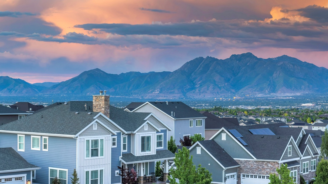 Panorama Dramatic sunset with clouds Panoramic view of Salt Lake City residential area in Utah. Top view of residential buildings and trees against the breathtaking mountain view and dawn sky at the background.